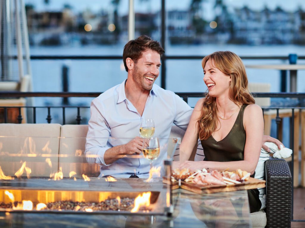 a man and woman laughing together on the patio