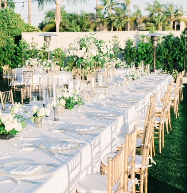 a long dining table with place settings for a wedding reception on the Bayfront Lawn