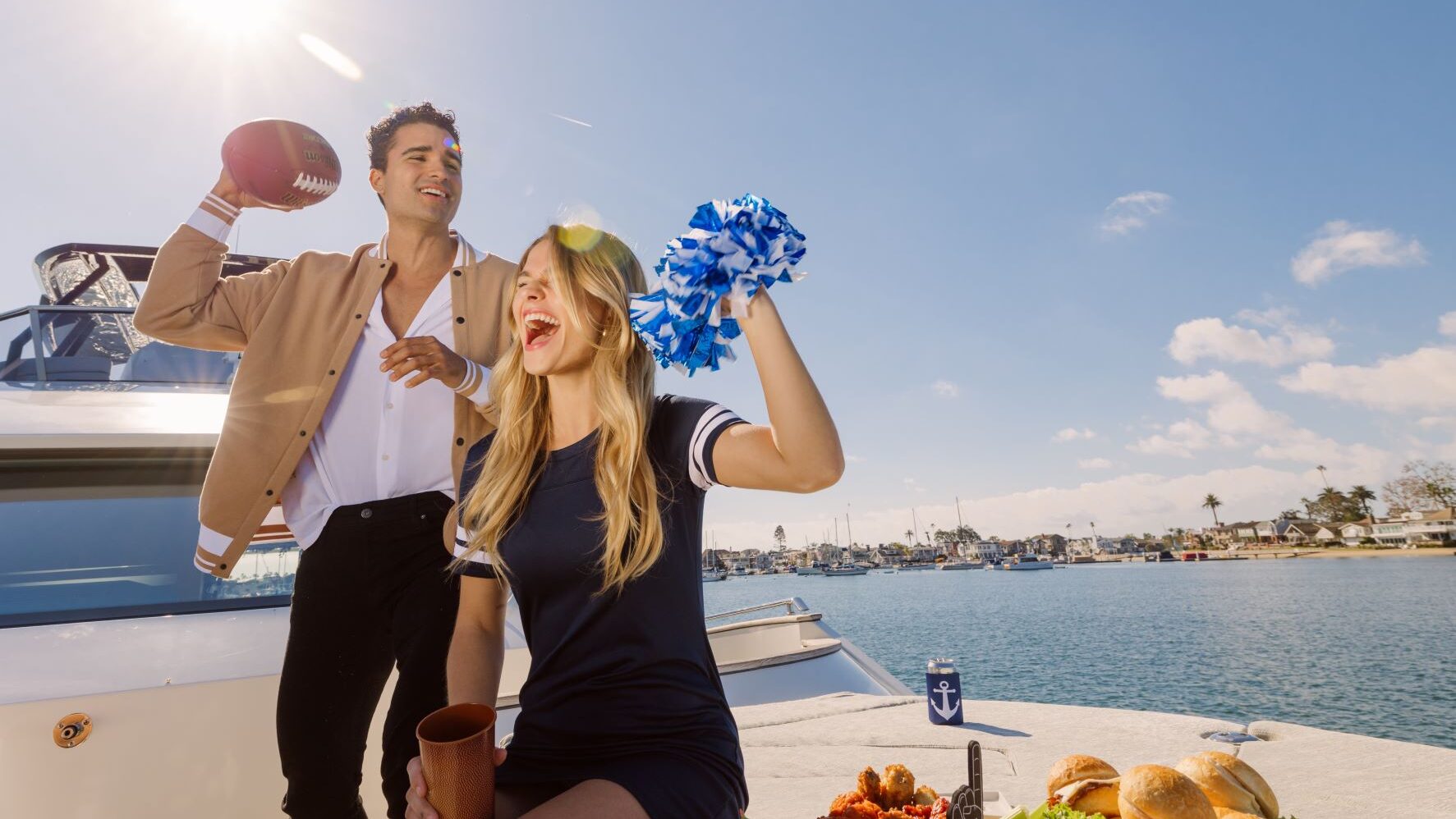 A quarter back and cheerleader celebrating on a Yacht near Balboa Bay Resort.